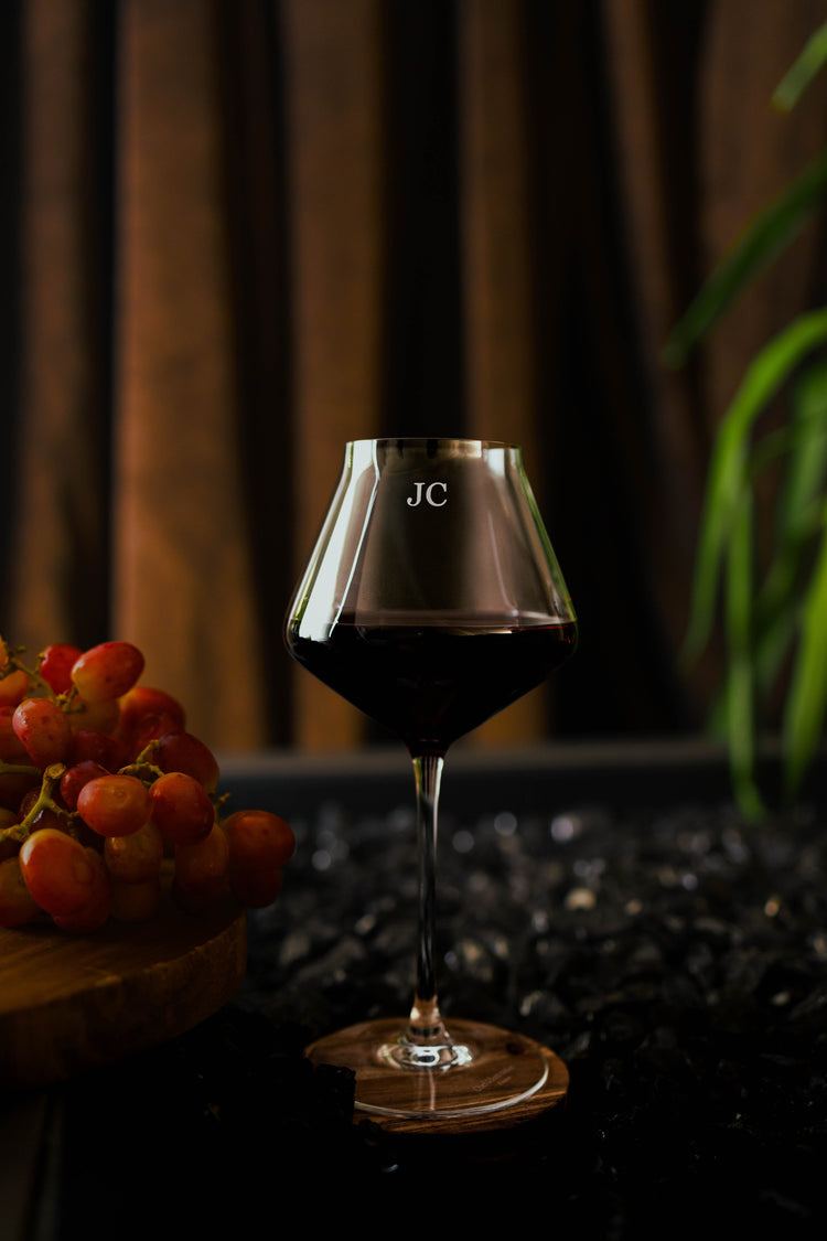 Single ruby red wine glass with engraved intials
